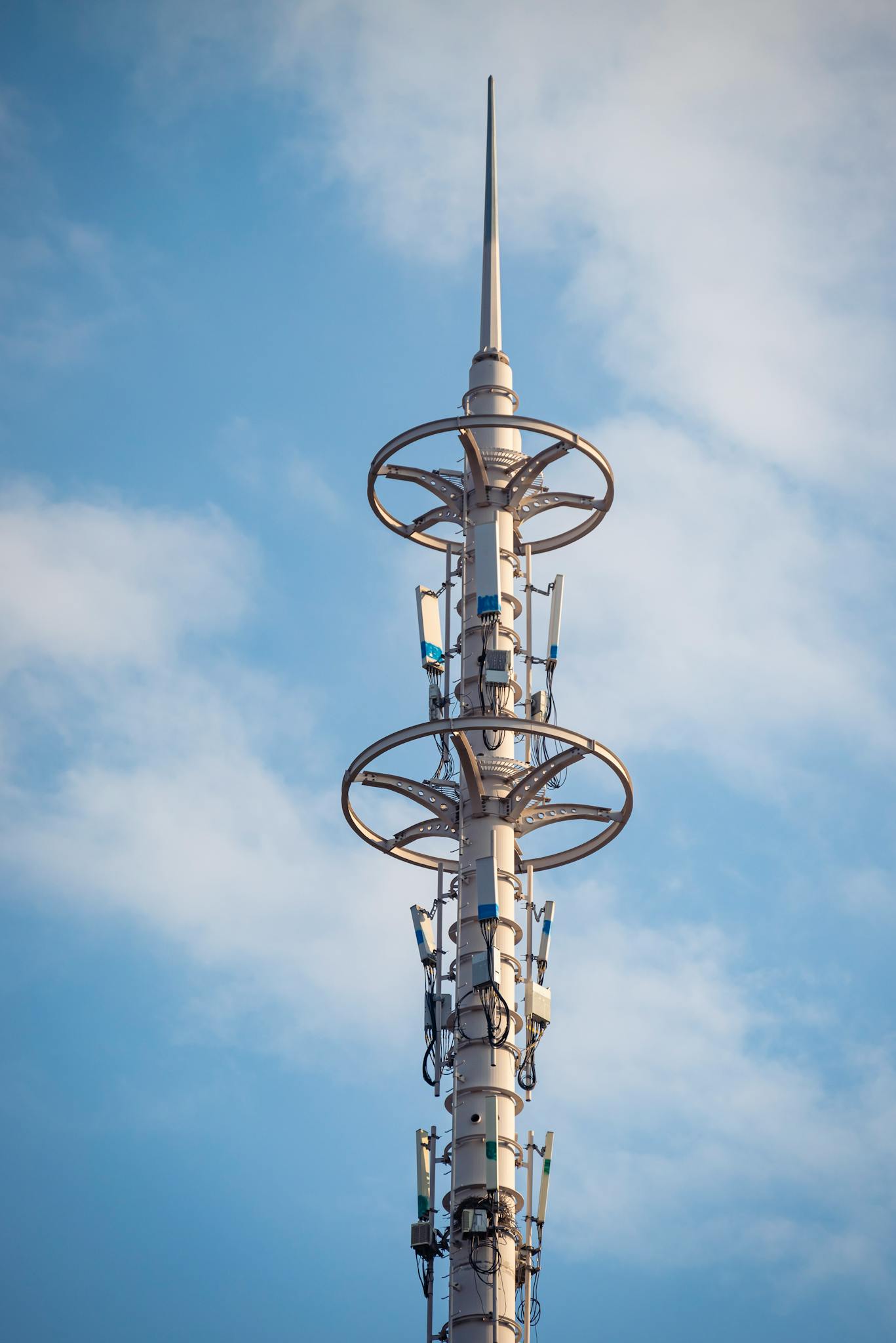A tall telecommunication tower with antennas under a clear blue sky, symbolizing modern connectivity.